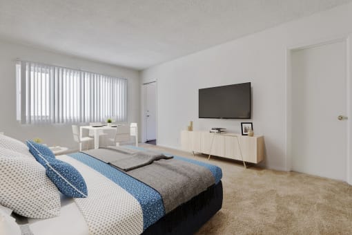 a bedroom with a bed and a television on the wall