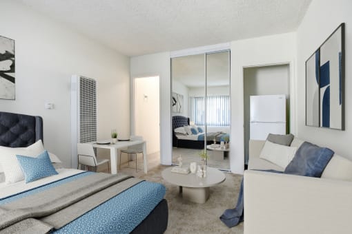 a bedroom with a bed and a desk and a mirror