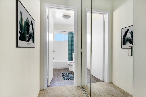 a bathroom with a mirror and a rug on the floor