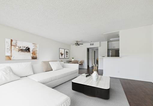 A living room with a white couch and a coffee table.