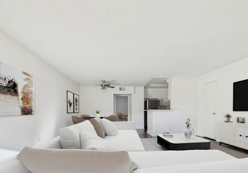 A modern living room with a grey sofa and a white coffee table.
