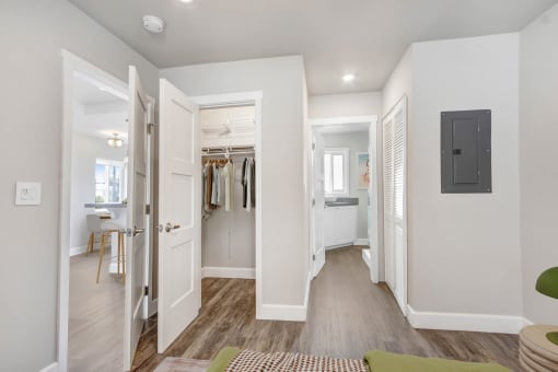 a bedroom with a closet and a door to a bathroom