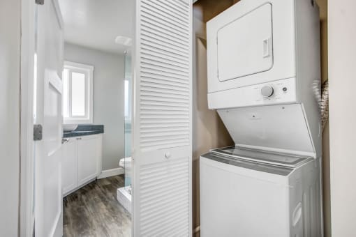 a white laundry room with a washer and dryer in it