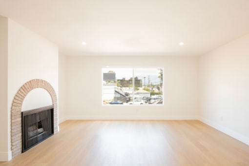 a living room with a fireplace and a large window