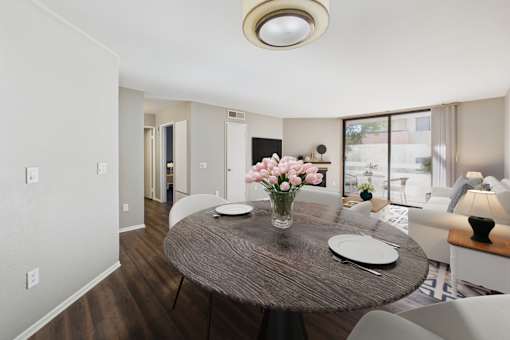 A dining room with a round table and chairs.