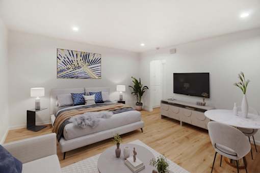 A modern bedroom with a large bed and a television in the corner.