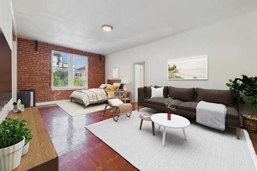 A living room with a brown couch, a white coffee table, and a red rug.