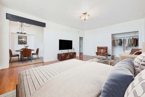 A living room with a large bed in the foreground.