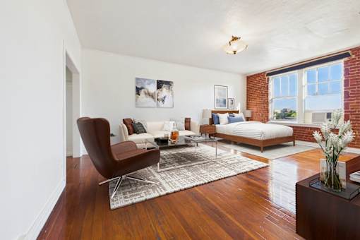 A living room with a brown chair and a white couch.