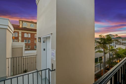 the view from the balcony of a condo building at sunset