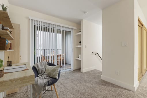 a living room with a couch and a chair and a sliding glass door