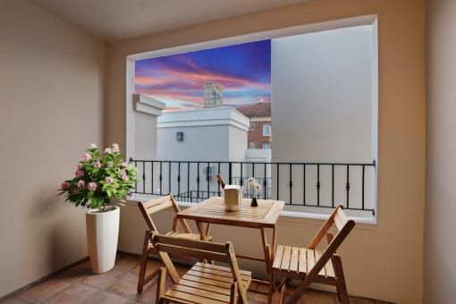 a balcony with a table and chairs and a large window
