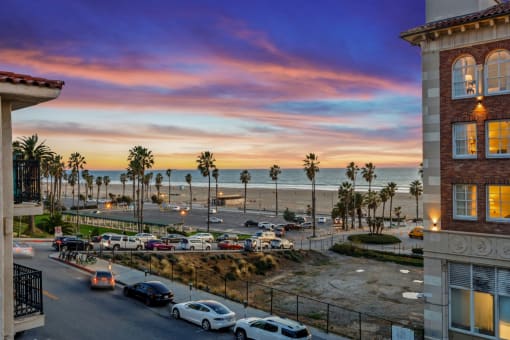 a view of the beach from a building at sunset