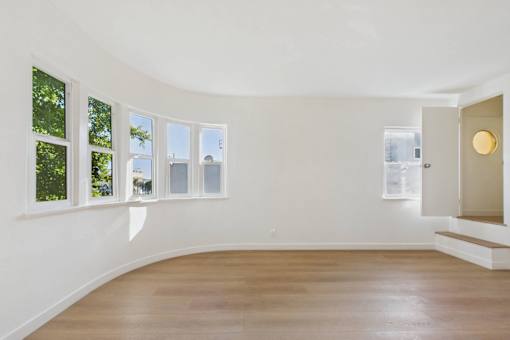 A room with a wooden floor and white walls.