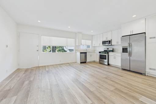 A kitchen with white cabinets and stainless steel appliances.