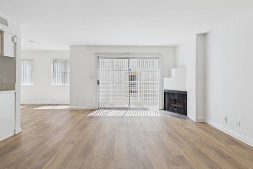 A room with a fireplace and a gate in the middle.
