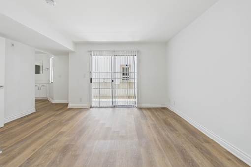 A room with wooden floors and white walls.