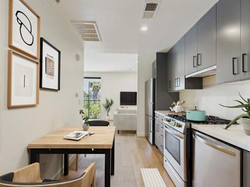 A modern kitchen with a table and chairs.