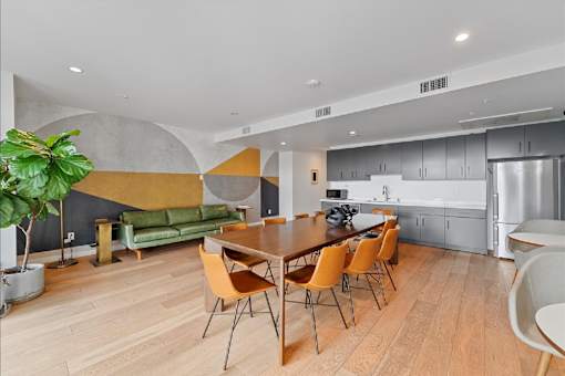 A modern dining room with a wooden table and chairs.