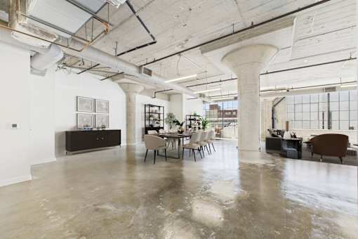 A large open space with a concrete floor and exposed ceiling beams.