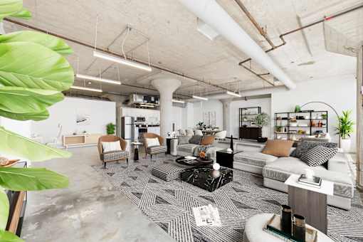 A modern living room with a grey carpet and white furniture.