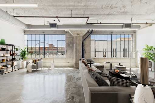 A modern living room with a concrete floor and a large window.