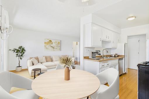 A modern kitchen with a dining table and chairs.