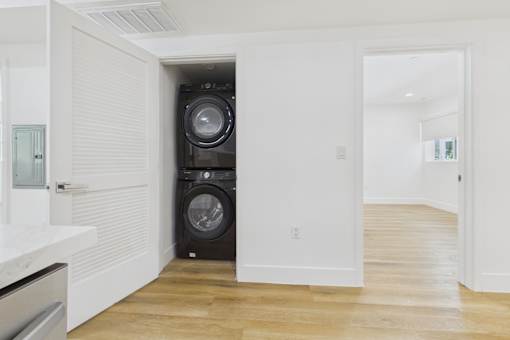 A laundry room with a washer and dryer stacked on top of each other.