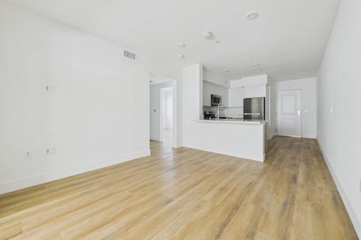 A kitchen area with a refrigerator, microwave, and oven.