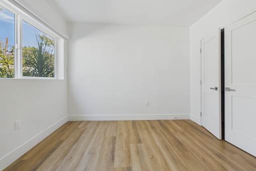 A room with a wooden floor and white walls.