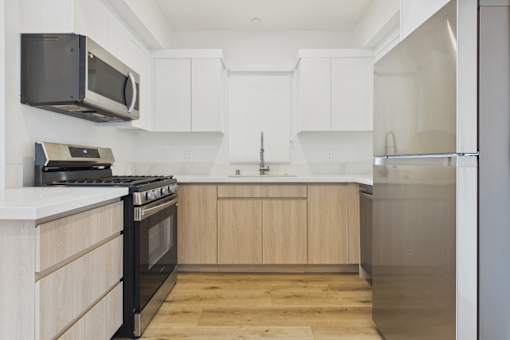 A kitchen with a black microwave above the stove.