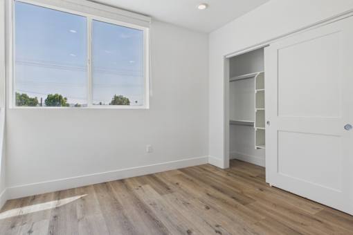 A room with a large window and a white door.