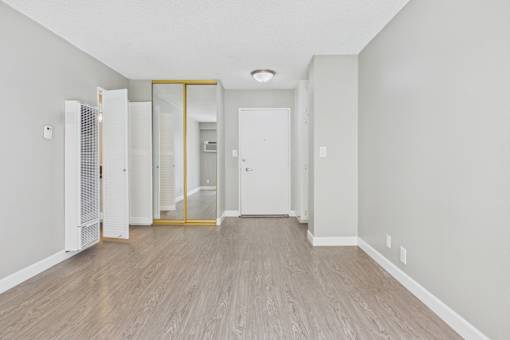 A room with a white door and a white wall.