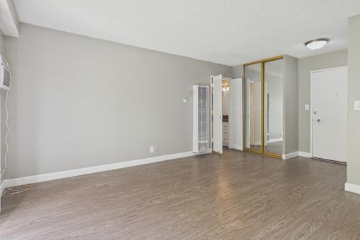A room with a wooden floor and a white ceiling.