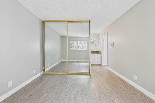 A room with a wooden floor and a glass door.
