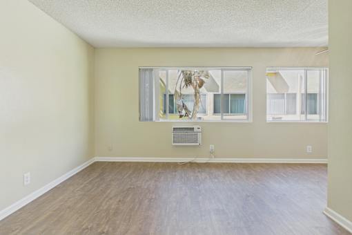 A room with a wooden floor and a large window.
