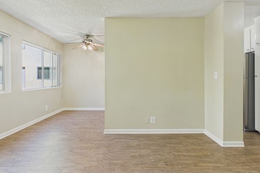 A room with a ceiling fan and a window.