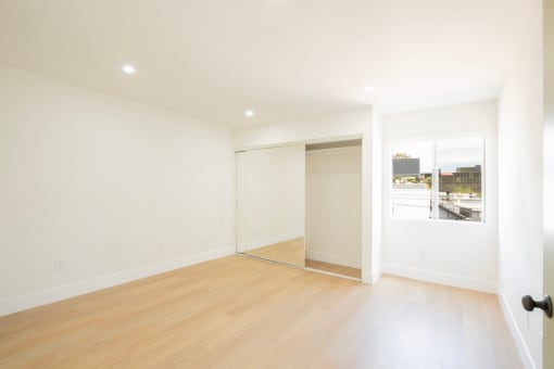 a living room with a wood floor and white walls