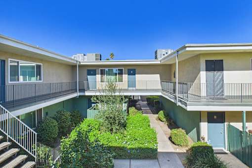 A sunny day at a residential complex with a clear blue sky.