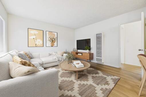 A living room with a white couch and a coffee table.