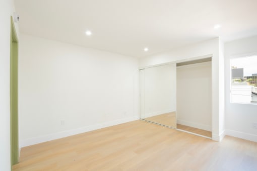 a living room with white walls and a sliding glass door