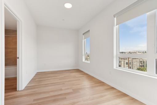 A room with a window overlooking a cityscape.