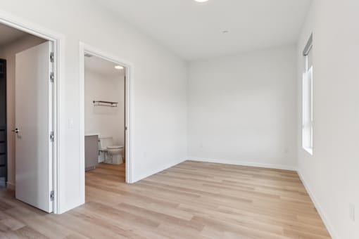 A room with a wooden floor and white walls.