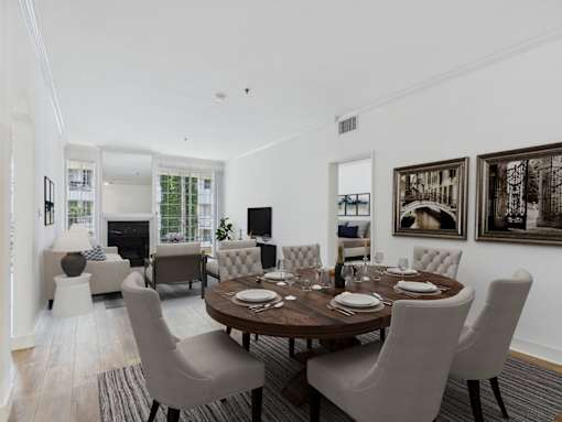 A dining room with a table set for six.