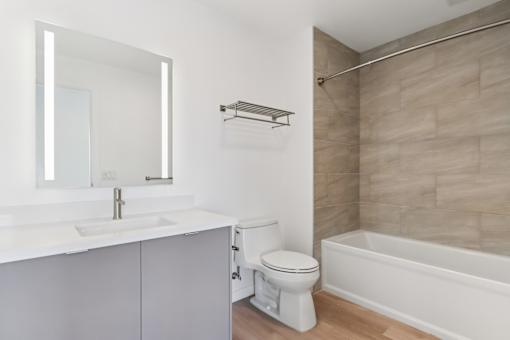 A white bathroom with a toilet, sink, and bathtub.