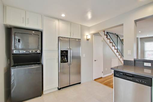 a kitchen with stainless steel appliances and white cabinets