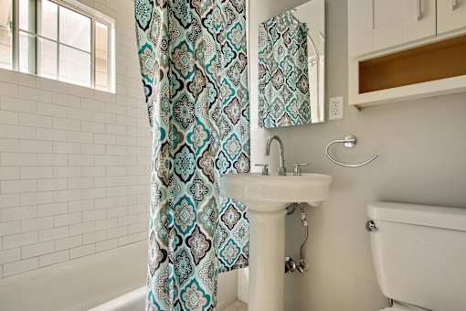 a bathroom with a sink and a shower curtain