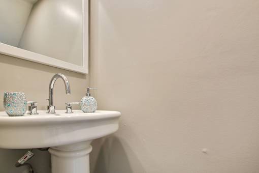 a small bathroom with a sink and a mirror