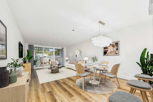 A modern dining room with a wooden table and chairs.
