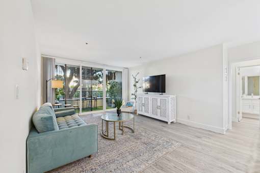 A living room with a green couch and a television.